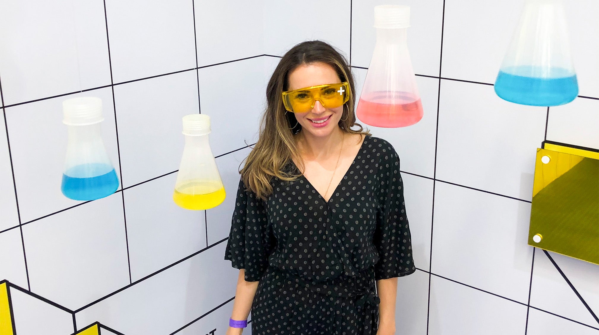 Dr. Anna Karp next to chemical flasks