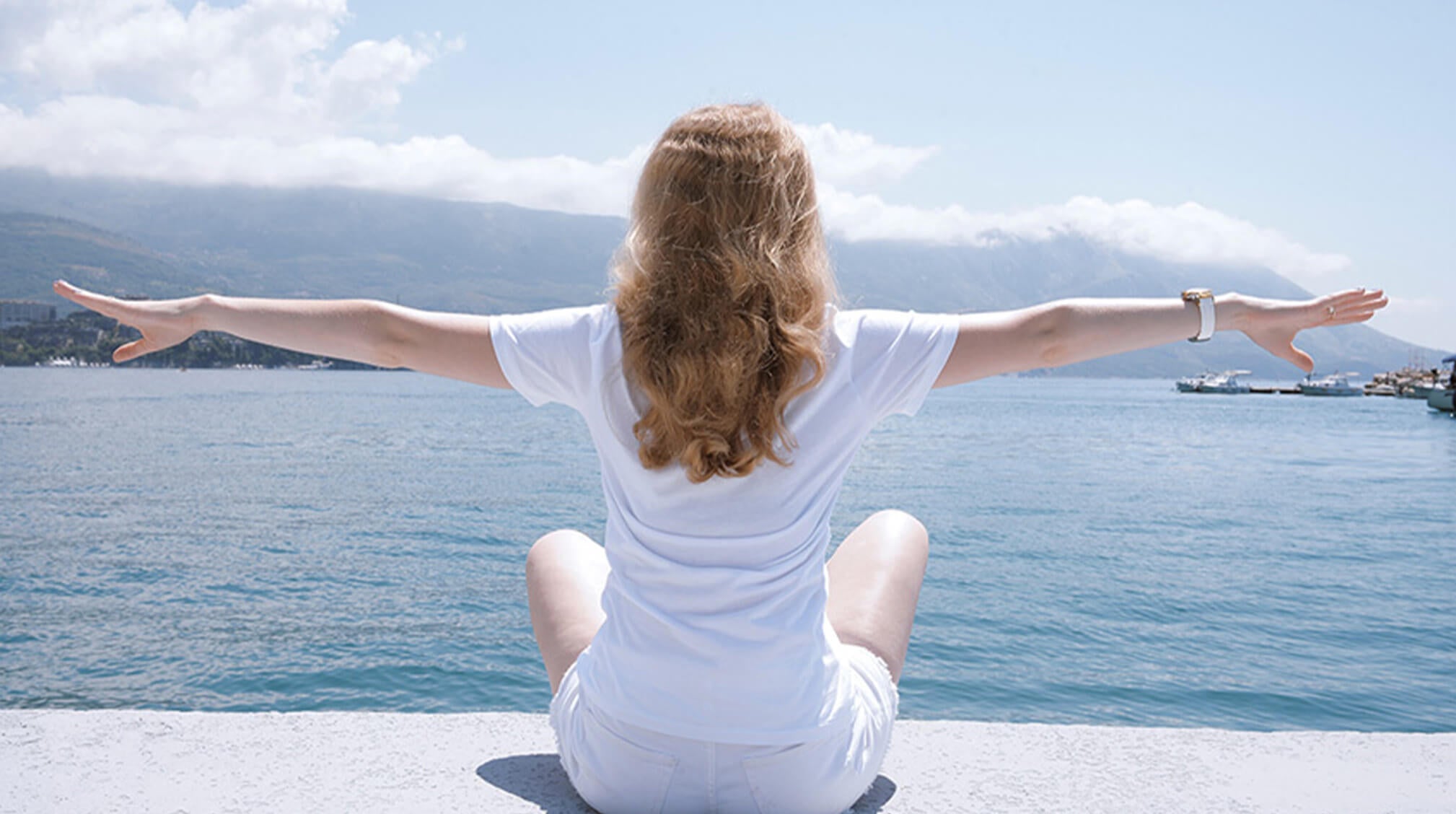 Woman with white apparel sitting in the sun