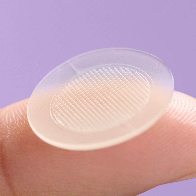 Close up of Mighty Patch™ for Dark Spots Micropoints™ patch on a finger.