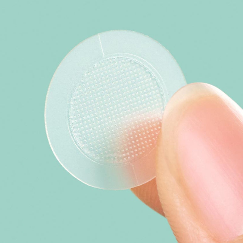 Close up of Mighty Patch™ for Early-Stage Blemishes patch on a finger.