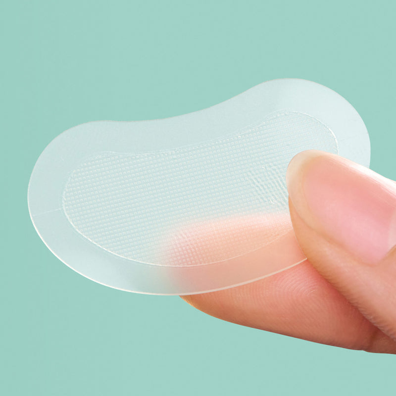 Close up of Mighty Patch™ for XL Early-Stage Blemishes patch on a finger.