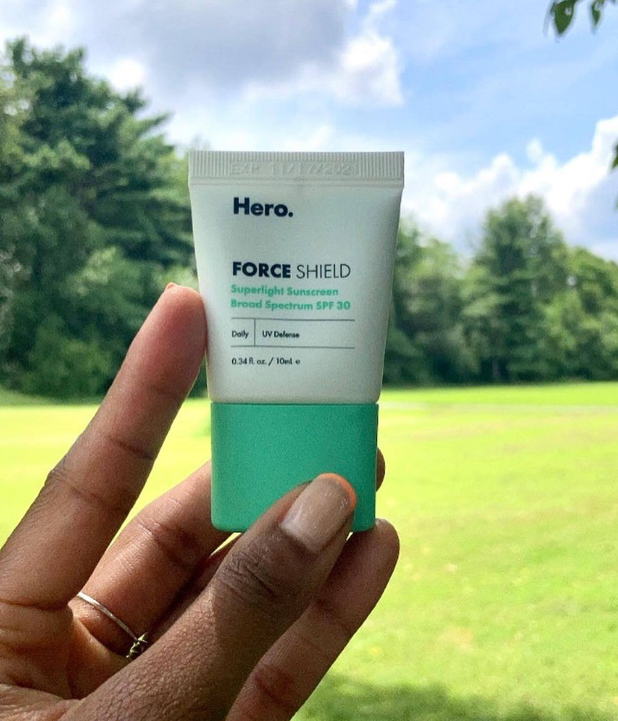 Instagram user @jasmm_skinjawn holding a mini Superlight Sunscreen SPF 30 