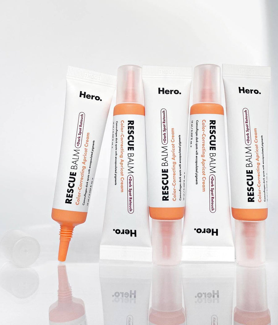 Group shot of 5 Rescue Balm +Dark Spot Retouch tubes