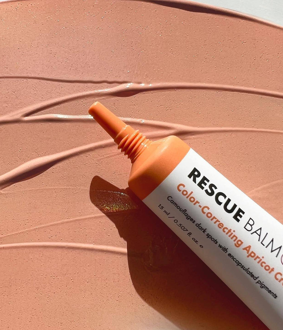 Swatch of Rescue Balm +Dark Spot Retouch and tube